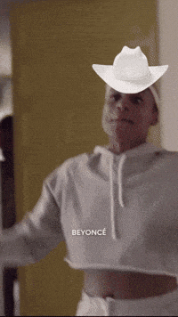 a man wearing a white cowboy hat with the word beyonce on the bottom