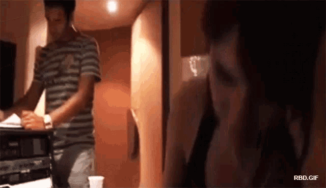 a gif of a man and a woman with rbd.gif in the corner