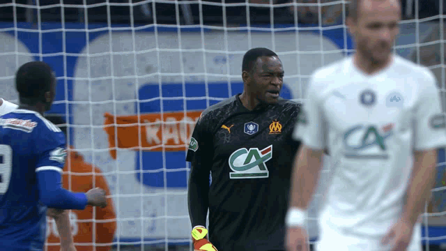 a soccer player wearing a black ca jersey