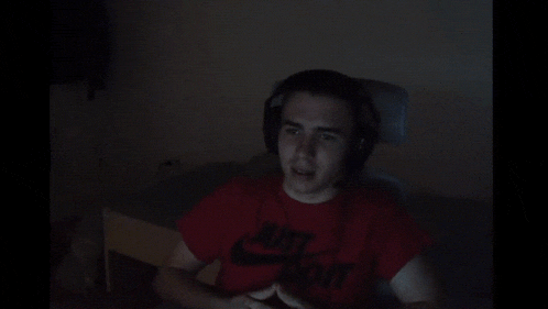 a man wearing headphones and a red shirt that says nike on it