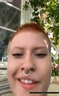 a close up of a woman 's face with a nose ring on it
