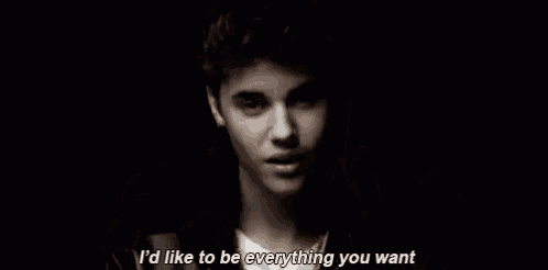 justin bieber is surrounded by a bunch of hands and says `` i 'd like to be everything you want '' .
