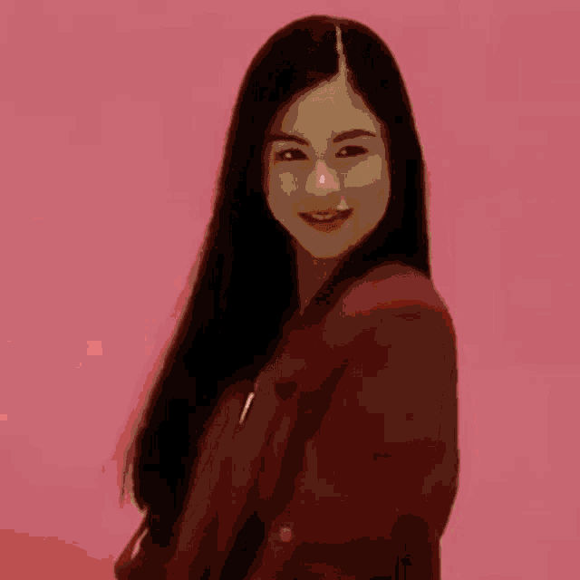a woman in a red dress has a white face .