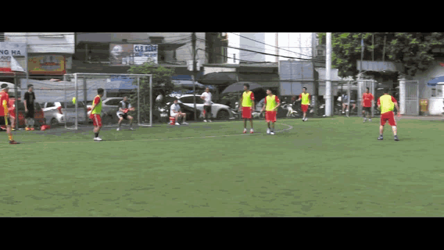 a group of soccer players are playing on a field with a sign that says ca dinh