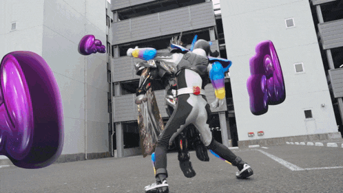 a person in a superhero costume is fighting another person