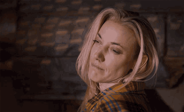 a woman in a plaid shirt is looking up with the words boring above her