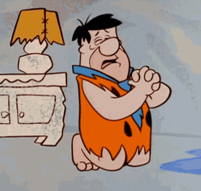 a cartoon of flintstone kneeling down with his hands folded