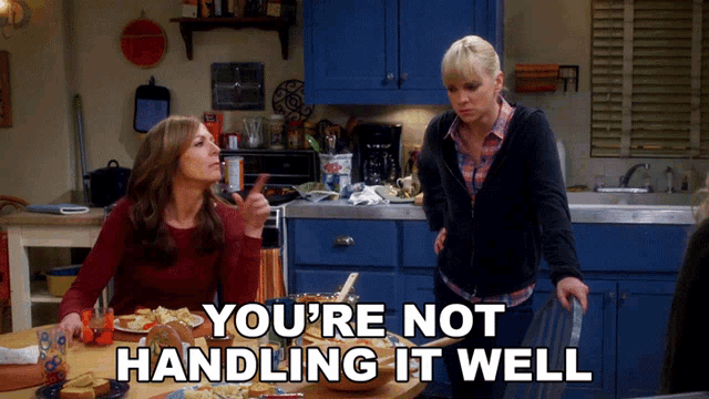 two women standing in a kitchen with the words " you 're not handling it well "