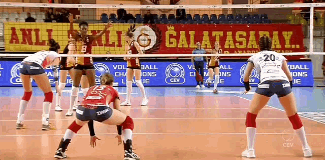 volleyball players on a court with a banner that says galatasaray