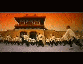 a group of people are dancing in front of a building that has the number 7 on the top