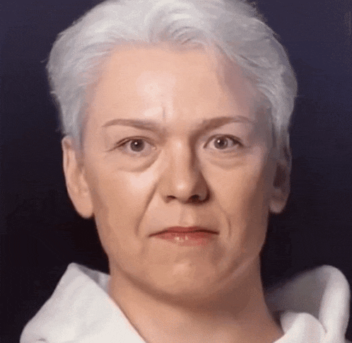a close up of a woman 's face with a serious look on her face