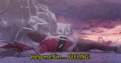 a person in a santa suit is laying in the snow and says help me i 'm feeling .