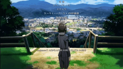 a man in a suit stands on a hill overlooking a city and mountains