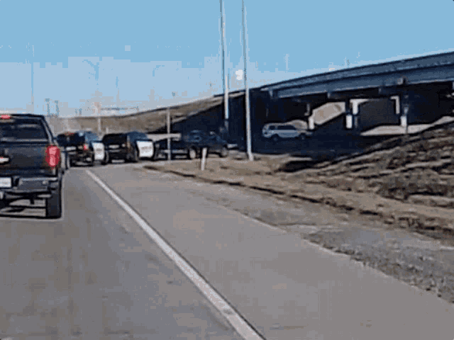 a row of cars are parked on the side of a road