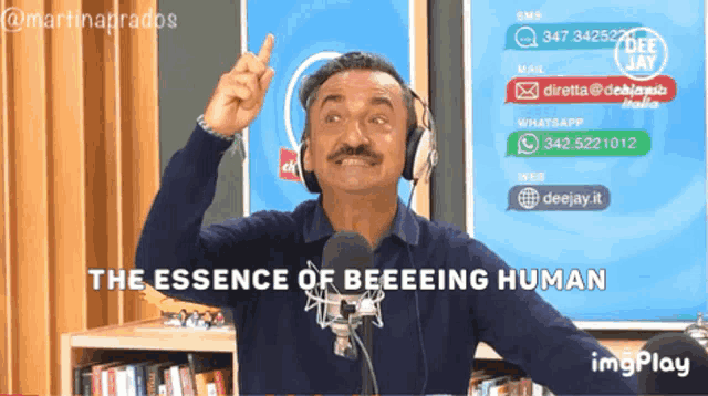 a man wearing headphones says the essence of beeeeing human