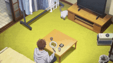 a man sits at a table with a plate of food and a can of soda
