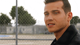 a close up of a man 's face with a black jacket on