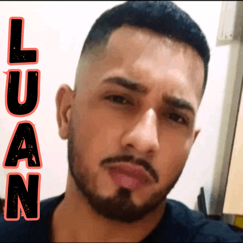 a man with a beard and the name luan on the bottom right