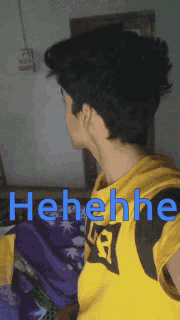 a man wearing a yellow shirt with the word henehene on it