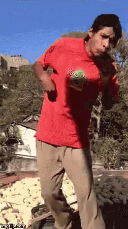 a man in a red shirt is holding a ball that says ' ita ' on it