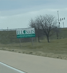 a sign that says illinois is on the side of the road