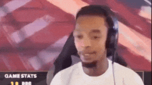 a man wearing headphones is looking at the camera .