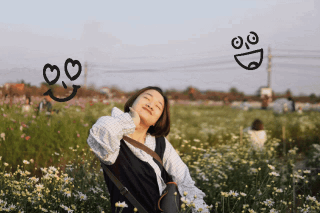 a woman stands in a field of flowers with a smiley face drawn on the window