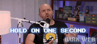 a man is talking into a microphone with the words hold on one second dark web written below him