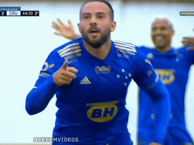 a man in a blue shirt with bh on the front