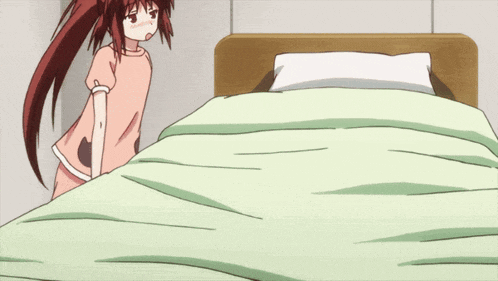 a girl with long red hair is laying on a bed