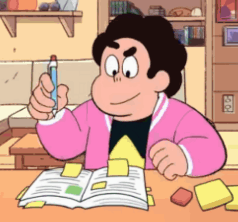 steven universe is sitting at a table with a book and a pen .