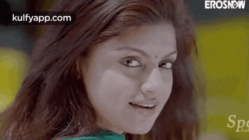 a close up of a woman 's face with a bindi on her forehead