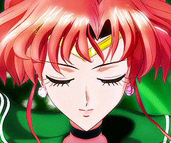 a close up of a girl 's face with red hair