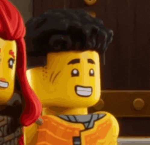 a close up of a lego man 's face with a smile on his face