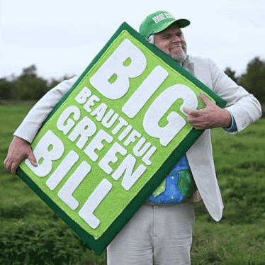 a man in a green hat holds a big beautiful green bill