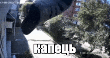 a person is standing in front of a building with trees in the background and a shoe flying through the air .