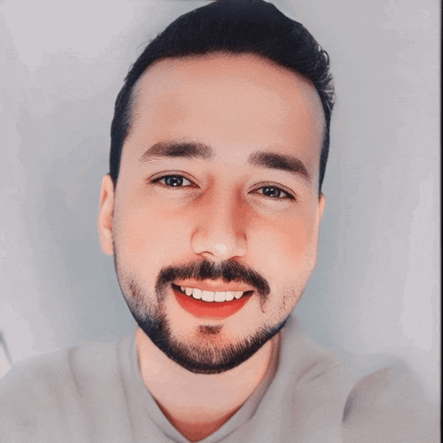 a man with a beard is smiling with the name amir in red