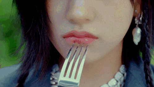a woman with a fork in her mouth