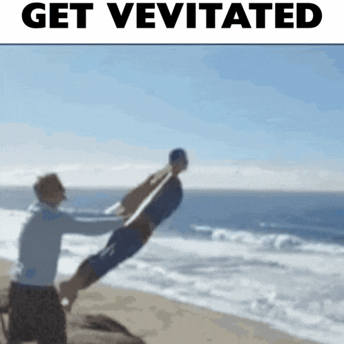 a man is holding another man up in the air on a beach with the words get vevitated above them