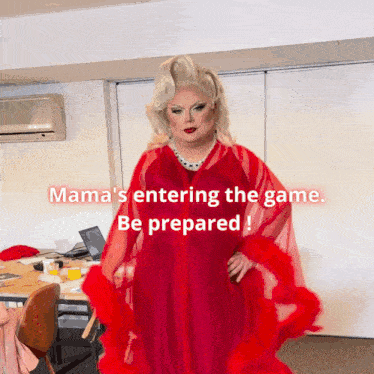 a woman in a red dress is standing in front of a sign that says mama 's entering the game be prepared