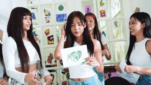 a girl holding a sign that says maggie
