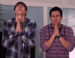 two men are praying with their hands together