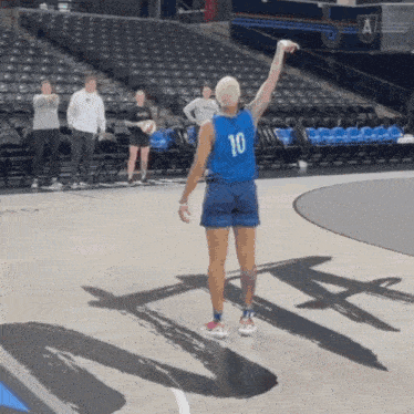a basketball player wearing a blue jersey with the number 10 on the back