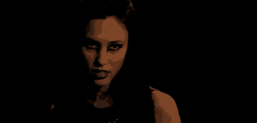 a close up of a woman 's face in the dark .