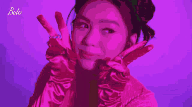 a woman wearing pink gloves with the word belo on the bottom right