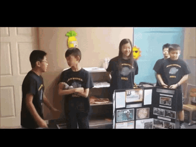a group of children wearing black shirts with the numbers 31021 on them