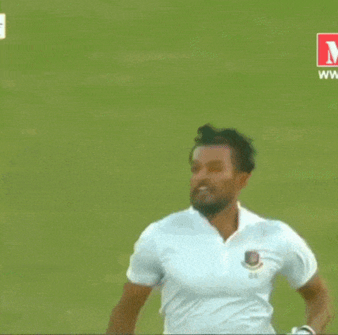 a man in a white shirt is running on a field while holding a bat .