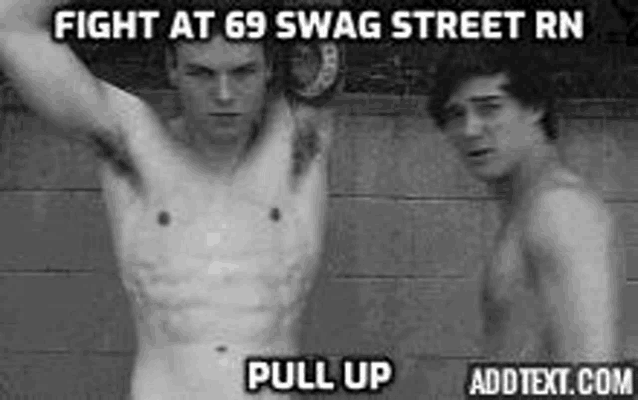 two shirtless men are standing next to each other in front of a wall .
