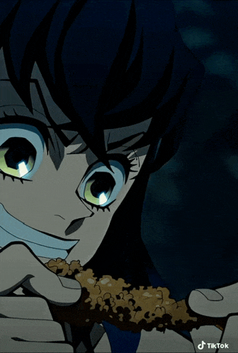 a close up of a person eating a piece of food with tiktok written on the bottom right