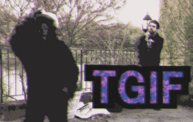 two men standing in front of a sign that reads tgif
